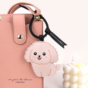 Pink PU leather crossbody bag with matching cartoon poodle charm and black ribbon decor