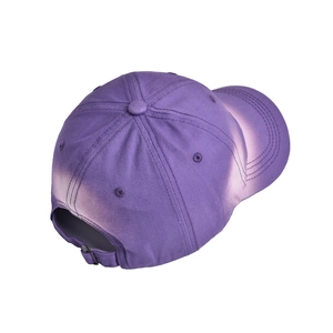 Detail of vintage faded purple cotton baseball cap showing distressed texture and metal buckle