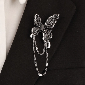 Gothic silver butterfly brooch with black enamel inlay and metal chain tassels