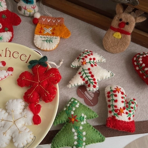 Detailed handmade wool felt Christmas ornaments featuring stars, trees and reindeer