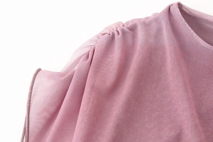Detail of soft pink mesh fabric with elegant pleated texture on the shoulder and neckline