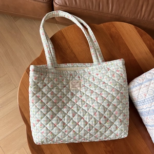 Macro detail of quilted floral cotton tote bag with vintage blue plaid and pink flowers
