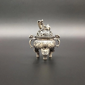 Macro view of vintage silver copper incense burner with dragon lid and tripod legs