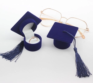 Detail of dark blue doctoral cap velvet jewelry box with tassel and ring inside