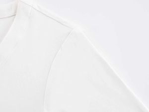 Close-up of V-neck stitching and soft knit fabric texture on white short-sleeved top