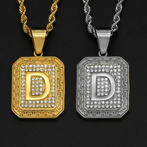 Detailed view of hip hop square D-letter pendants with rhinestones in gold and silver