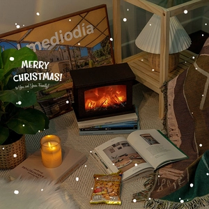 Mini electric tabletop fireplace with warm glowing LED flame effect for Christmas decor