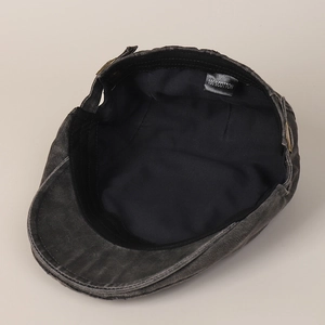 Vintage dark grey washed cotton newsboy cap showing internal 100% cotton lining and label