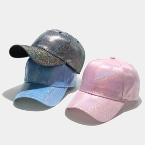 Macro shot of shimmering laser PU leather fabric on stylish colorful baseball caps