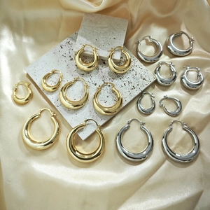 Minimalist 18K gold and silver plated hollow hoop earrings in assorted sizes on stone