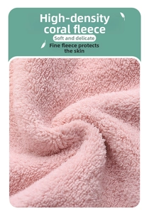 Detailed close-up of soft high-density coral fleece fabric in a gentle pink shade