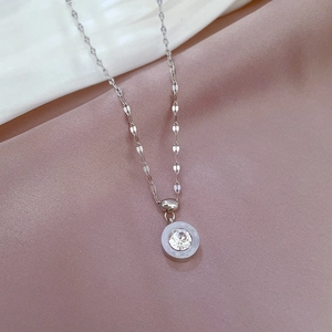 Macro shot of silver roman numeral necklace with a sparkling crystal center stone