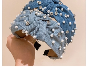 Close-up of denim knotted headbands with sparkling rhinestones and white faux pearls
