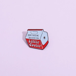 Detail of enamel pin shaped like a cooler with text Don't Hate Me Because I'm A Little Cooler