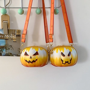 Close-up of pumpkin crossbody bags with orange gradient finish and festive smiley face