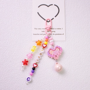 Detail of pink LOVE beaded keychain with pixel heart pendant and star beads