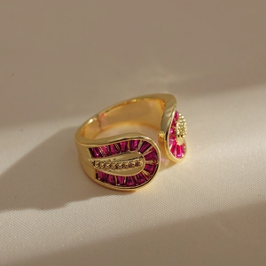 Detailed macro view of gold-plated double-layer ring with pink zircon and bead accents