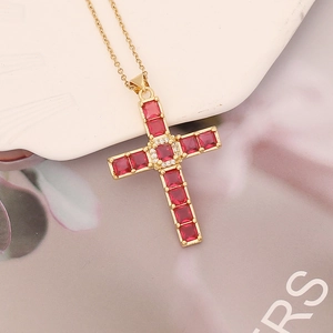 Cross necklace pendant with gold plating featuring red square and white round zirconia stones