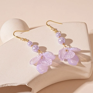 Elegant acrylic flower petal earrings with purple pearls and gold hooks for a resort look