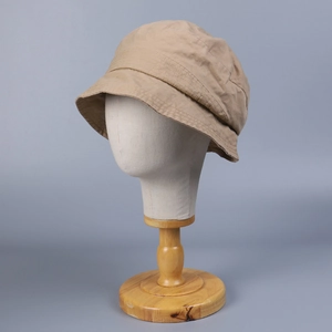 Detail of khaki washed cotton bucket hat showing natural texture and stitching quality