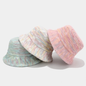 Three colorful knitted bucket hats in light blue, beige, and pink purple for winter
