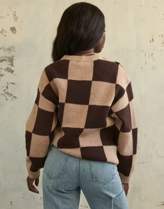 Detail of checkered knit sweater in brown and beige colors showing the back fit