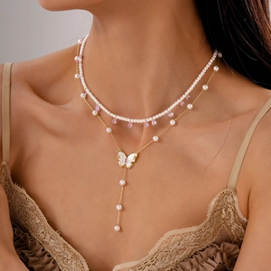 Elegant multi-layer necklace with white pearls, butterfly pendant and pink zircon teardrop