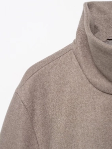 Close-up of oatmeal wool jacket showing high collar design and premium fabric texture