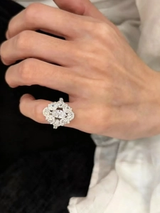 Detailed macro shot of a marquise-cut zircon cluster ring on a female finger