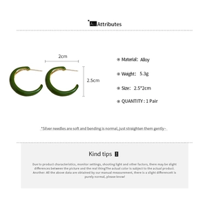 Detailed view of dark green C-shaped alloy hoop earrings with silver needle measurement