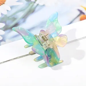 Macro view of pearlescent butterfly hair claw clip with colorful acetate finish