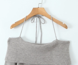 Detail of grey ribbed knit off-shoulder dress with halter ties and textured fabric