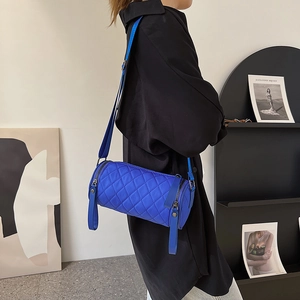Chic quilted cylindrical crossbody bag in electric blue nylon with adjustable strap
