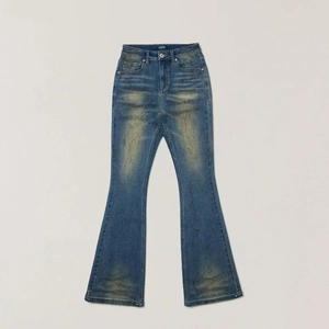 Detail of vintage blue flared denim jeans featuring yellow wash finish and hand-painted texture