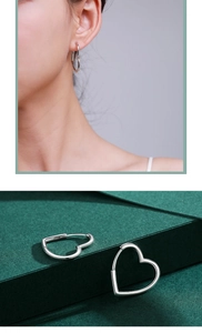 Close-up and model view of polished silver heart-shaped hoop earrings for women