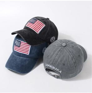 Close-up of three vintage washed cotton baseball caps with USA embroidery in multiple colors