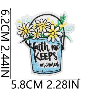 Detailed view of floral embroidered patch with dimensions 6.2cm x 5.8cm on white background