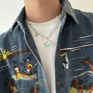 Close-up of beaded necklace with light blue shell, pearl, and silver starfish charms