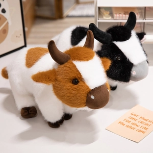 Realistic brown and black plush cow stuffed animals in a cozy home setting