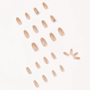 Faux ongles cercueil dégradé nude avec bords pailletés argentés et strass de papillon
