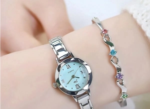 Detail of silver women's watch with light blue dial and matching gemstone bracelet