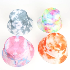 Detail view of tie-dye bucket hats in grey, rainbow, pink-blue, and orange-white colors