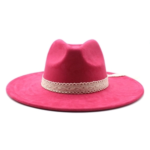 Detail of rose red wide brim fedora hat featuring beige lace band and wool felt texture
