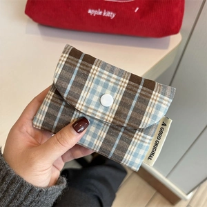 Detail shot of mini vintage plaid coin purse with snap button closure and side label