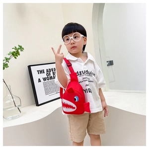 Detail of red cartoon shark chest bag for kids with 3D fins and adjustable strap