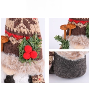 Detailed view of Christmas gnome with snowflake knit hat, pine needles and wooden accents