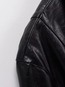 Close-up of premium black leather jacket featuring detailed stitching and fine texture