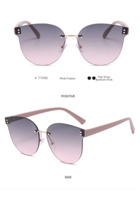 Detail view of pink frameless cat eye sunglasses with grey-pink gradient lenses