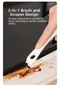 Close-up of a 2-in-1 kitchen cleaning brush scraper removing stubborn grease stains