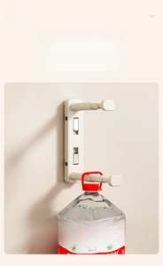 Wall-mounted suction cup rack holding a large water bottle to demonstrate high load capacity